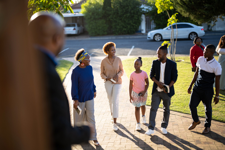 A warm group of church members walking together on a sunny pathway, illustrating the supportive fellowship and family atmosphere to expect when visiting an evangelical church in The Republic of Benin.